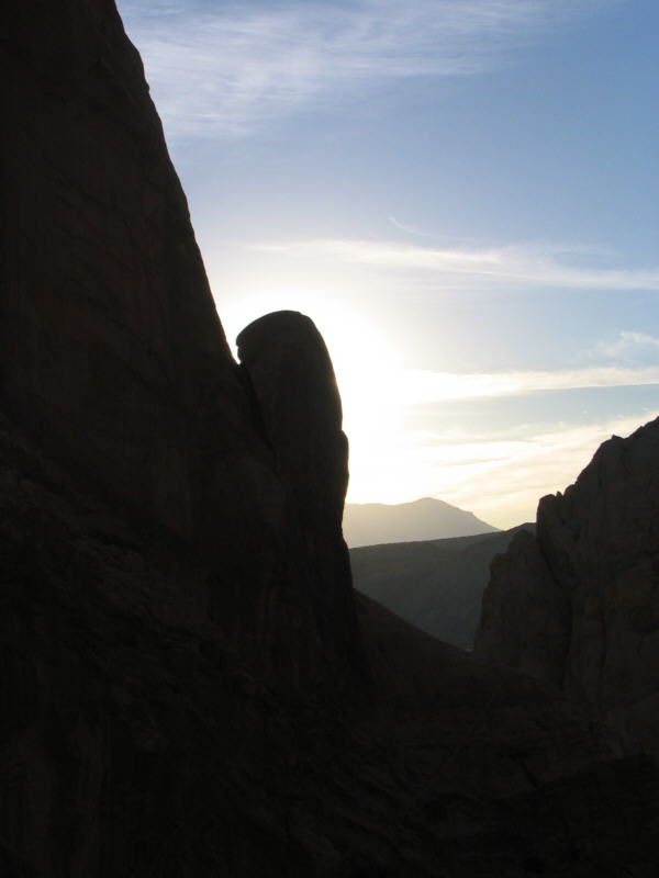sun hides behind a sandstone fin.