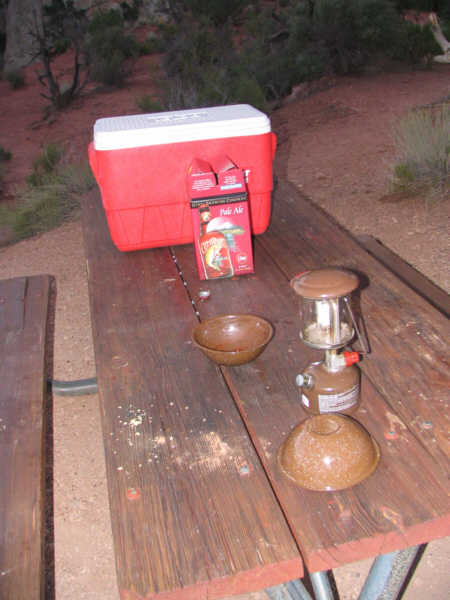 standard brown table, red and white cooler, lantern