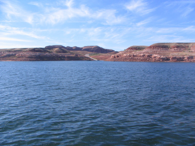 a rich blue body of water set in the desert.