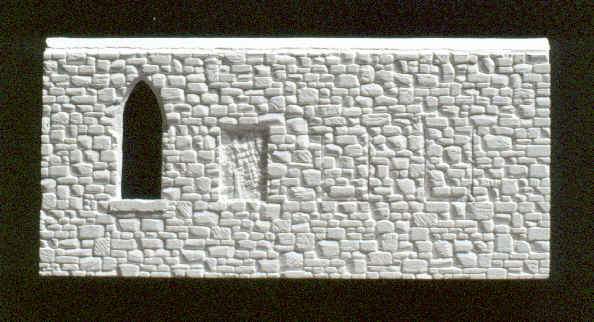 Photo of window openings being cut into stone wall.