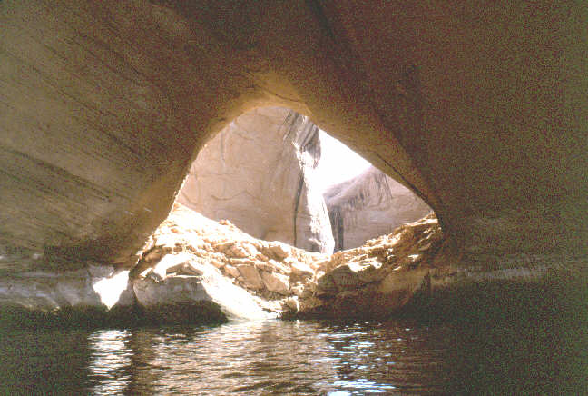 A small hole in a large sandstone wall.