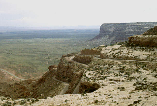 The road turns to gravel and abruptly descends 1500 ft. by switchbacks
