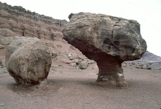 two ver large rocks, one shaped like a mushroom